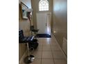 Inviting foyer featuring neutral tile flooring and decorative elements at 1639 Nestlewood Trl, Orlando, FL 32837