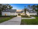 Beautiful home exterior features lush landscaping, elegant entryway, and unique architectural details at 1906 Oakbrook Dr, Longwood, FL 32779