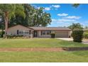 Charming one-story house with well-manicured lawn, driveway, and exterior painted in neutral tones at 1912 Wyandotte Trl, Casselberry, FL 32707