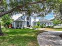 Charming two-story home with lush green lawn, mature trees and inviting curb appeal at 2147 Whitfield Ln, Orlando, FL 32835