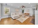 Bright living room with hardwood floors, modern furnishings, a ceiling fan, and ample natural light at 216 E Vanderbilt St, Orlando, FL 32804