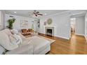 Spacious living room featuring a decorative fireplace, hardwood floors, comfortable seating, and stylish decor at 216 E Vanderbilt St, Orlando, FL 32804