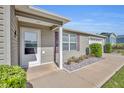 Inviting front entrance featuring a covered porch and neat landscaping at 2192 Kerwood Loop, The Villages, FL 32162