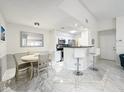 Inviting dining area flowing into the kitchen, offering a seamless and stylish living space at 232 Afton Sq # 201, Altamonte Springs, FL 32714