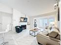 Bright living room features a fireplace, TV, couch, and lots of natural light at 232 Afton Sq # 201, Altamonte Springs, FL 32714