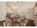 Dining room with wood floors, elegant table setting, modern decor, and a staircase in the background at 2611 Albion Ave, Orlando, FL 32833