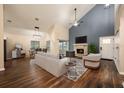 Bright living room with vaulted ceilings, fireplace, and wood-look floors, creating a modern and inviting space at 2611 Albion Ave, Orlando, FL 32833
