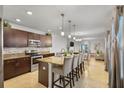 Modern kitchen featuring stainless steel appliances, granite countertops, a spacious island, and eat in bar at 3065 Timber Hawk Cir, Ocoee, FL 34761