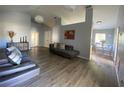 Spacious living room with vaulted ceilings, laminate flooring, and modern decor at 3124 Ginger Cir, Orlando, FL 32826