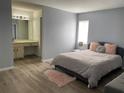 Serene main bedroom featuring laminate floors and a full ensuite bathroom at 3124 Ginger Cir, Orlando, FL 32826