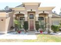 Stunning front entrance boasts beautiful landscaping and a welcoming design at 3200 Town And Country Rd, Oviedo, FL 32766