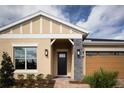 Beautiful view of the home's front entry, showing the well-maintained lawn and stylish accents at 3285 Songbird Cir, Harmony, FL 34773