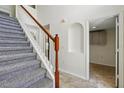 Carpeted staircase with white banister and wood handrail leads to the upper level at 343 Grand Royal Cir, Winter Garden, FL 34787