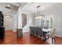 Bright dining room with elegant chandelier, hardwood floors, and large windows at 3535 Lake Sarah Dr, Orlando, FL 32804