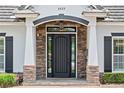 Elegant front door with stone accents, sidelights and decorative details at 3535 Lake Sarah Dr, Orlando, FL 32804