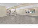 Spacious open-concept living area with recessed lighting, tile flooring, and a modern kitchen at 3713 Dover St, Orlando, FL 32806
