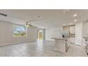 Bright open-concept living space with tile flooring, seamlessly connects to the modern kitchen at 439 Sarah Nicole Way, New Smyrna Beach, FL 32168