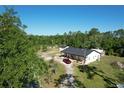 Aerial view of a white house and red truck surrounded by lush greenery at 456 Baron Rd, Orlando, FL 32828