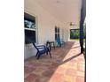 Covered front porch with tiled floor, chairs and ceiling fan at 456 Baron Rd, Orlando, FL 32828