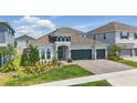 Well-maintained two-story home with a three-car garage, manicured lawn, and stone accents at 4779 Cragmere Loop, Clermont, FL 34711