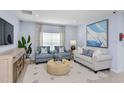 Cozy living room with light blue walls, comfortable seating, stylish decor and plenty of natural light at 4928 Bluebell Ct, Lake Hamilton, FL 33851