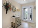 Bright foyer with tile floors, decorative mirror, and stylish console table by the front door at 5510 Siracusa Ln, Sanford, FL 32771