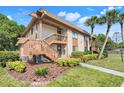 Condo featuring a neatly kept lawn, verdant trees, and a serene setting at 600 N Boundary Avenue # 119A, Deland, FL 32720