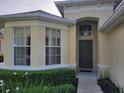 Inviting home exterior with beautiful landscaping and an arched entryway at 643 Orista Dr, Davenport, FL 33897