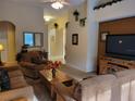 Comfortable living room with neutral tones, arched doorway, and ceiling fan at 643 Orista Dr, Davenport, FL 33897