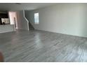 Bright living room with tile flooring, staircase, and a window that lets in natural light at 6712 Golden Eagle Blvd, Howey In The Hills, FL 34737