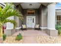 Inviting front porch with seating, columns, and meticulous landscaping at 7237 Edmund Ct, Mount Dora, FL 32757