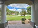 View from the covered porch showcasing the meticulously maintained landscape and serene neighborhood at 7237 Edmund Ct, Mount Dora, FL 32757