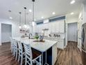 Spacious kitchen with a large island, modern lighting, stainless steel appliances, and ample cabinet space at 7748 Four Seasons Blvd, Kissimmee, FL 34747