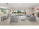Bright living room featuring neutral walls, plush seating, and sliding glass doors that lead to an outdoor pool area at 7867 Horse Ferry Rd, Orlando, FL 32835