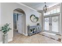 Bright foyer features tile floors, an arched doorway, and a decorative table at 8037 Bangle Ln, Orlando, FL 32836