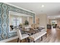 Bright dining room showcases an elegant table setting and a large decorative mirror at 976 Commons Way, Port Orange, FL 32129
