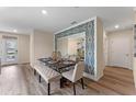 Open concept dining area with modern furniture and a decorative wall mirror at 976 Commons Way, Port Orange, FL 32129