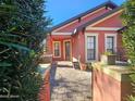 Inviting front entrance with brick pavers, colorful exterior, and manicured landscaping, offering curb appeal at 141 Campanello Ct, Daytona Beach, FL 32117