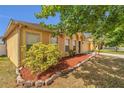 Charming exterior view with manicured landscaping, stone accents, and a well-maintained lawn at 5091 Plymouth Turtle Cir, St Cloud, FL 34772