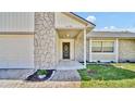 Inviting front entrance with stone facade and manicured landscaping at 1458 Heather Way, Kissimmee, FL 34744