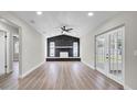 Spacious living room with stone fireplace, wood-look floors, and bright natural light at 1458 Heather Way, Kissimmee, FL 34744