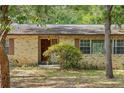 A well-maintained home with a prominent front entrance, brickwork, and mature tree in the foreground at 180 Broadmoor Rd, Lake Mary, FL 32746