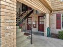 Brick condo building entrance with stairs leading to upper units and doorways below at 200 Saint Andrews Blvd # 2306, Winter Park, FL 32792
