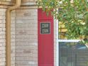 Red shutters highlight the brick facade of this condo unit with easy to read numbers at 200 Saint Andrews Blvd # 2306, Winter Park, FL 32792