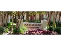 Four Seasons Condominium sign with manicured landscaping and flowers at 200 Saint Andrews Blvd # 2306, Winter Park, FL 32792