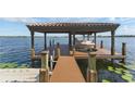 Waterfront home featuring covered boat dock with lift and beautiful water views at 7624 Pointe Venezia Dr, Orlando, FL 32836