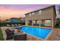 Backyard pool and patio, ideal for outdoor relaxation and entertaining with ample seating at 7644 Fairfax Dr, Kissimmee, FL 34747