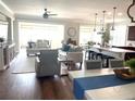 Bright and spacious living room featuring an open-concept design, hardwood floors, and large windows at 9872 Sw 75Th Street Rd, Ocala, FL 34481