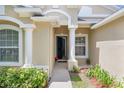 Inviting front entrance with decorative columns and manicured landscaping at 1438 Portmoor Way, Winter Garden, FL 34787