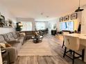 Bright open-concept living room with a cozy sectional and hardwood floors at 308 Rustic Loop, Sanford, FL 32771